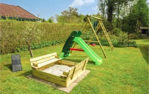 a playground with a green slide and a swing at Holiday Home Lillevangsvej in Jægerspris +17 photos