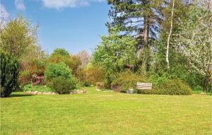 a park bench sitting in the middle of a field at Holiday Home Lillevangsvej in Jægerspris
