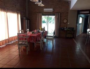 a dining room with a table and chairs in a room at Casa de verano confortable in Villa Las Rosas
