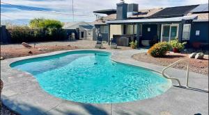 a swimming pool in front of a house at Spacious Getaway! Pool, Spa, Sleeps 9 in Lake Havasu City