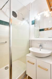 a white bathroom with a sink and a shower at Quartier La Forêt - maeva Home - Studio 4 personnes - Sélection MAE-1241 in Valmorel +32 photos