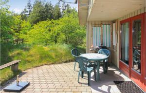 a patio with chairs and a table on a house at Holiday Home Nørre Nebel 42 in Lønne Hede