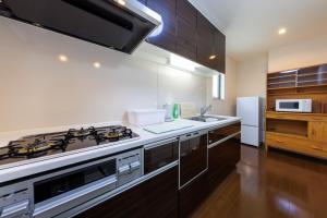a kitchen with a stove and a sink at ReStayしっぽタウンヴィラ今宮駅 in Osaka +54 photos