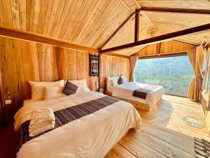 Postel nebo postele na pokoji v ubytování Na Thẩm Eco Hill Homestay - Trạm Tấu