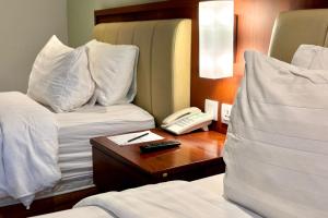 Ένα ή περισσότερα κρεβάτια σε δωμάτιο στο Thong's Inn Hotel Kualanamu