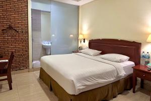 Ένα ή περισσότερα κρεβάτια σε δωμάτιο στο Thong's Inn Hotel Kualanamu