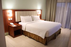 Ένα ή περισσότερα κρεβάτια σε δωμάτιο στο Thong's Inn Hotel Kualanamu