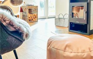 Una sala de estar con una silla y una chimenea. en Ankerglueck Buesum, en Büsum