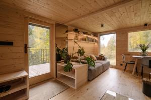 a living room with a couch and a table and a window at Chalet Tré in Čenkovice