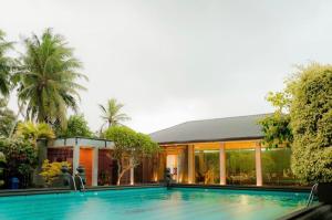 a house with a swimming pool in front of a house at Ranowell Hotel in Negombo
