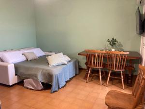 a room with a bed and a table and chairs at La casa di Trude in Padenghe sul Garda