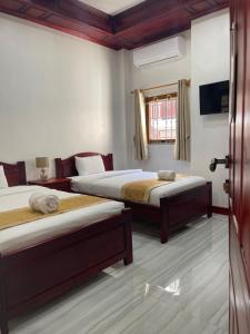 Postel nebo postele na pokoji v ubytování PhaiLin Hotel