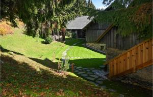 a house with a wooden fence and a yard at 2 Bedroom Stunning Apartment In Mozirje in Mozirje