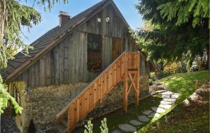 a house with a wooden staircase leading to it at 2 Bedroom Stunning Apartment In Mozirje in Mozirje +9 photos