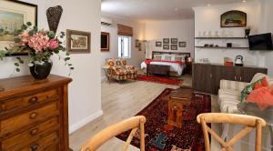 a living room with a couch and a bedroom at Rosedene Guest House in Cape Town