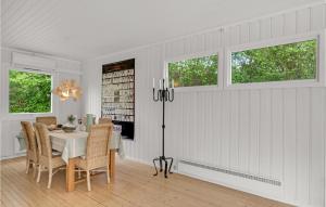 a white dining room with a table and chairs at Pet Friendly Home In Hornbæk With Wifi in Hornbæk