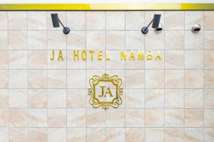a sign for a hotel named jla hotel nambila at JA Hotel Namba in Osaka