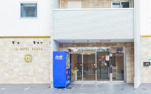 a building with a ticket machine in front of it at JA Hotel Namba in Osaka