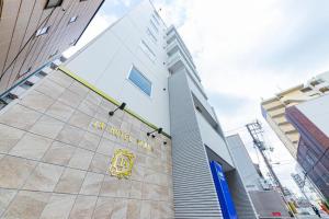 a building with a yellow sign on the side of it at JA Hotel Namba in Osaka