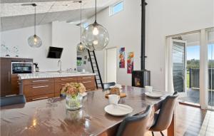 Una cocina y un comedor con mesa y sillas. en Three-Bedroom Holiday Home In Hemmet, en Falen