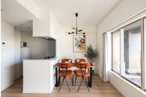 a kitchen with a table and four chairs at Dash Living Asakusa East in Tokyo