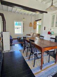 a living room with a wooden table and chairs at Majestic Secret in Cape Town +11 photos
