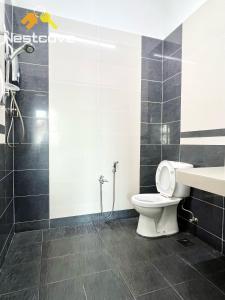 a bathroom with a toilet and a shower at Harmony Stay Ujung Pasir By Nestcove in Melaka +12 photos