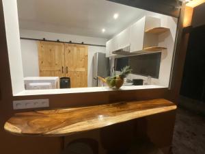 a kitchen with a counter with a wooden counter top at Tepoea Lodge in Fare