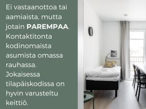 a room with a bed and a table with a window at Hiisi Homes Turku Fleminginkatu in Turku