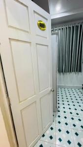 a white door in a bathroom with a tile floor at Lucky 2 Hotel in Trà Vinh +50 photos