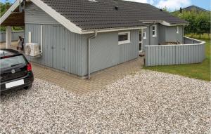 a garage with a car parked in front of it at Holiday Home Marie Nielsens Vej Glesborg Denm in Fjellerup Strand