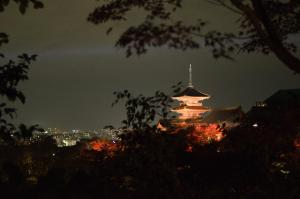 a pagoda at night with a city in the background at Four Points Flex by Sheraton Kyoto Oike in Kyoto