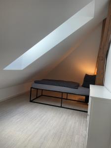 a room with a bed in the attic at Ferienwohnung Westblick in Arneburg