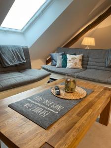 a living room with a couch and a table at Ferienwohnung Westblick in Arneburg