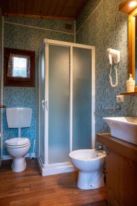 a bathroom with a shower and a toilet and a sink at Agri Village Pavia in Certosa di Pavia +26 photos