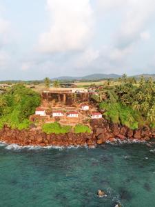 an aerial view of a small island in the ocean at Red Crab Eco Resorts in Cabo de Rama