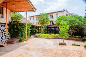 a courtyard with a tree and a building at Kigali diplomat Hotel in Kigali