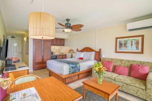 a living room with a bed and a couch at Islander on the Beach 154 in Kapaa +46 photos