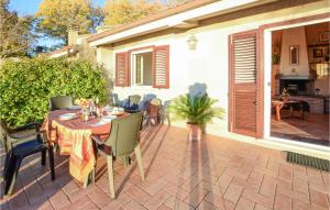 a patio with a table and chairs and a house at Awesome Home In San Savino Di Magione in San Savino +20 photos