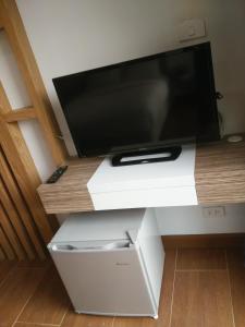 a flat screen tv sitting on top of a tv stand at The SR Residence Lampang in Lampang