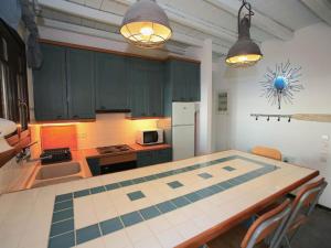 a kitchen with a table in the middle of it at Stunning seafront apartment in Kea in Korissia