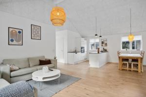 a living room with a couch and a table at Sommerhus i Arrild Ferieby nær Vesterhavet in Arrild