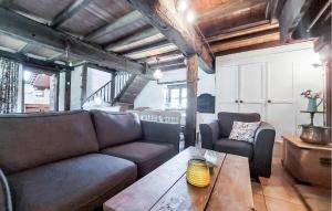 a living room with a couch and a table at 2 Bedroom Nice Home In Le Ferré in Le Ferré