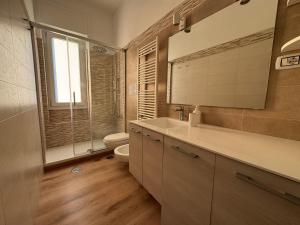 a bathroom with a toilet and a sink and a mirror at B&B Compare Felice in Salerno