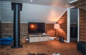 a living room with a flat screen tv and a fireplace at Pet Friendly Home In Gol With Sauna in Gol