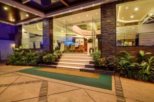 a lobby of a building with stairs and plants at Akshaya Aura in Bengaluru