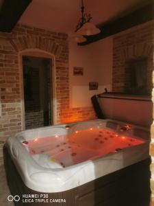 a hot tub in a room with a brick wall at Kúria Apartman Private Wellness in Budapest +37 photos