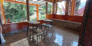 a row of stools in a bar in a restaurant at Hotel Lallangan in Makale