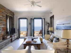 a living room with a couch and a table at Your seaside luxury retreat in Greece with private beach in Korissia