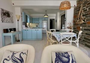 a kitchen and living room with a table and chairs at Your seaside luxury retreat in Greece with private beach in Korissia